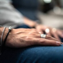 Close up in male hands with silver jewelry